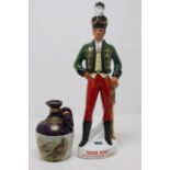 An Irish Mist ceramic decanter in the form of a soldier, unopened plus a Rutherfords whisky decanter