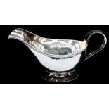 A George VI planished sauce boat by AE Jones, Birmingham 1937, pattern no: 630 stamped to underside,