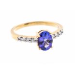 A tanzanite and diamond 18ct gold ring, comprising a claw set oval tanzanite approx8 x 6mm, to