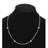 An 18ct white gold and pearl station chain comprising alternate round cultured pearl, approx 5.5mm