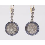 A pair of Art Deco sapphire and diamond gold target earrings, comprising a circular drop pave set to