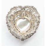 A Victorian heart shaped pierced bonbon dish, reticulated border, raised on openwork scroll base,