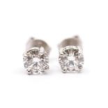 A pair of diamond and 18ct white gold stud earrings, comprising a claw set round brilliant cut