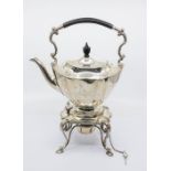 A George V silver tea kettle, stand and burner, shaped oval with ebony finial and handle, the