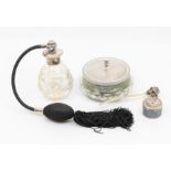 An Elizabeth II glass dressing table powder / toilet bottle, with engine turned silver cover,