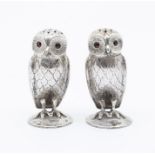 A pair of late Victorian silver novelty pepper pots realistically cast in the form of Owls, with