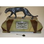 An Art Deco mantle clock, the onyx and marble case with spelter panther surmount enclosing a