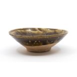 A Brown Glazed Bowl Possibly Yuan Dynasty, the rounded sides rising from a short, splayed foot,