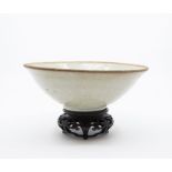 A Song Dynasty Qingbai Bowl. The rounded sides rising from a short foot to an everted unglazed rim