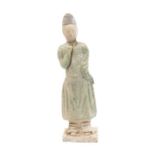 A Ming Dynasty Pottery Tomb figure of a male attendant wearing a flowing robe Date: Ming Dynasty