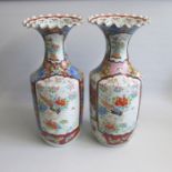 A pair of late 19th century Japanese vases, with flared fluted top rims and painted with panels of