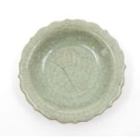 A Ming Dynasty Longquan Celadon Dish, the rounded sides rising from a short foot to a wide everted