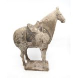 A small Tang Dynasty unglazed model of a Horse, standing four square with pricked ears on a