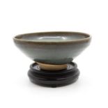 A Yuan Dynasty Jun circular bowl, the rounded sides rising from a short, tapered foot to a