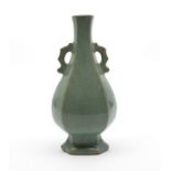 A Qing Dynasty small two handles baluster vase the rounded faceted body rising from a stepped foot