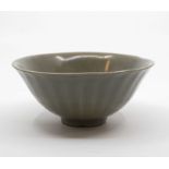 A Song/Yuan Dynasty Longquan Celadon fluted rice bowl, the rounded fluted sides rising from a