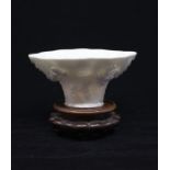 A Qing Dynasty. Dehua Blanc de Chine porcelain Libation Cup shaped as a Rhinoceros horn, the