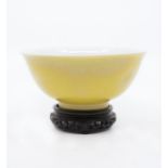 An Imperial Yongzheng yellow glazed bowl, the rounded sides rising from a straight foot to a