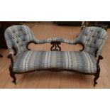 A Victorian mahogany two seater conversation chaise longue with retro cover and button back