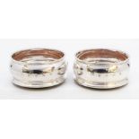 A pair of Modern Irish silver wine coasters, turned wooden bases, hallmarked by T Weir & Sons.,
