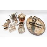 A collection of silver plated items including a candelabra, ice bucket, shakers, condiments, teapots