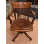 A 1930/40's oak swivel chair on splayed legs, along with a mid 20th Century cake stand