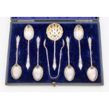 A set of six Edwardian silver ornate twist handles teaspoons together with sugar tongs and sifting