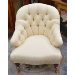 A reproduction Victorian style button back lounge chair on castors