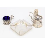 A collection of silver to include: a George V silver pierced holder with blue glass liner, the