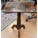 A 19th Century oak rectangular tilt top wine table, on tripod stand, three section top, feet cut (