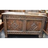 A 17th Century carved oak coffer of small proportions carved to front and sides