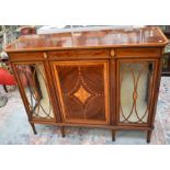 An Edwardian cabinet having two glass-panelled sides with batwing inlay and central inlaid