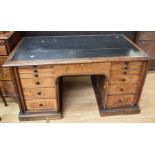 An early 20th Century oak writing desk with black leather writing surface, top central drawer with