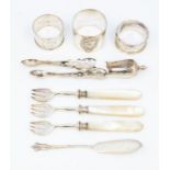 Three various silver napkin rings (one Continental) with sugar nippers and three mother-of-pearl