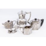 A white metal tea set, sugar bowl and jug (hinged cover of sugar bowl missing), together with a