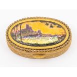 A French gilt metal and enamel oval shaped snuff box, the cover painted with castle on cliff with