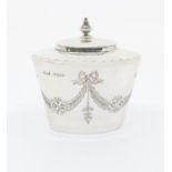 A George V silver tapering small tea caddy, the body engraved with ribbon tied swags of foliage, the