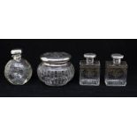 A collection of four silver mounted toilet bottles to include:  1. A pair of Edwardian cologne /