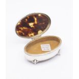 A George V silver and tortoiseshell oval ring box, the cover inset with three horizontal stripes,