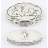 An Edwardian oval cut glass ring box, the silver cover chased with 18th Century Bride and Groom,