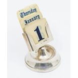 A George V silver perpetual desk calendar stand on circular base, with printed ivorine date,