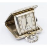 An Art Deco silver miniature travel clock, the silvered dial with painted Arabic numbers markers,