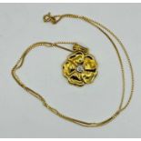 A yellow gold flower pendant with brilliant cut diamond, estimated diamond weight 0.20 ct, on a fine