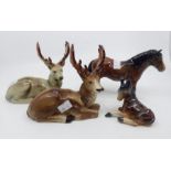 Two Bretby models of recumbent stags, a Bretby standing horse and a recumbent foal, largest 17cm