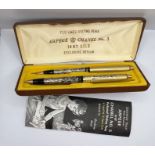 Arpege and Chanel No. 5 pair of 14kt gold plated "Perfumed Pens" in original box with paperwork. (