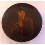 19th C papier-mâché circular box , painted with a man smoking a pipe with a jug of ale on a table .