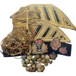 A collection of mostly antique military buttons, bullion fringing, insignia pips, epaulettes and