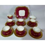 An Aynsley tea service for six to include cream jug, sugar basin with claret band and tooled gilt