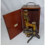 A brass microscope in a wooden case , H Crouch London