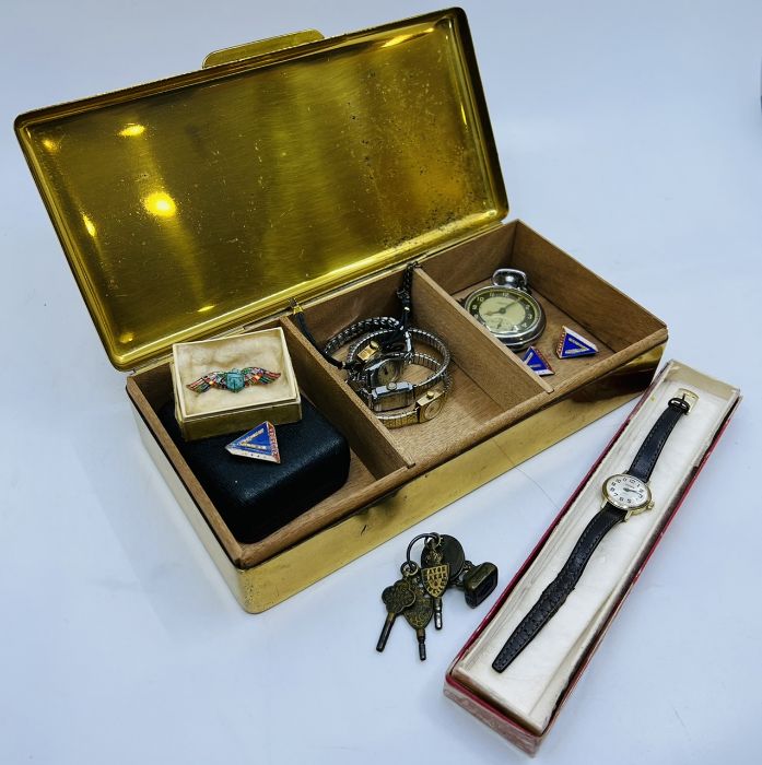 Brass box containing five ladies wrist watches; an Ingersoll triumph pocketwatch on a brass